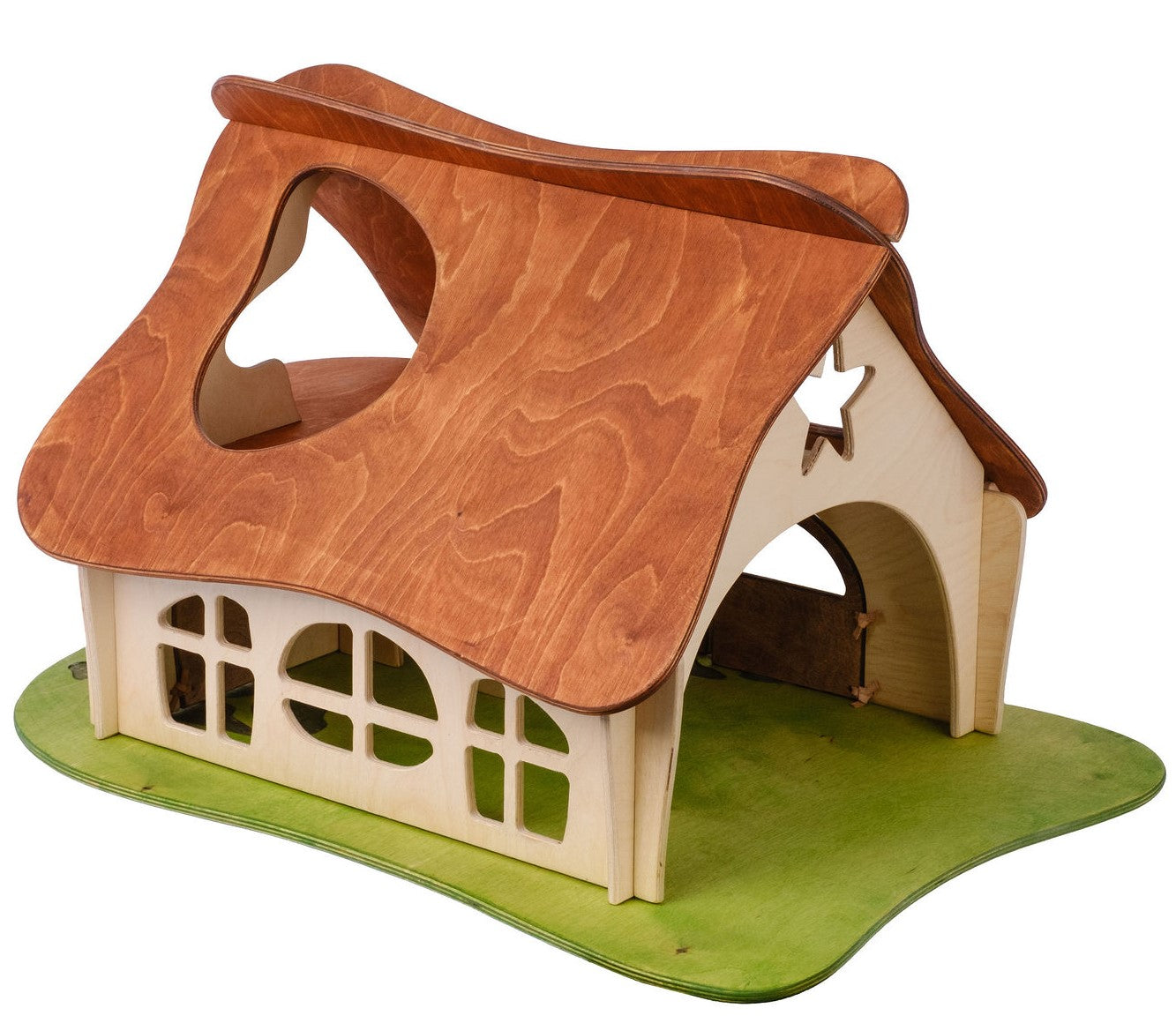 A medium-sized wooden dollhouse with a thatched roof and multiple windows, set on a green base that represents grass.